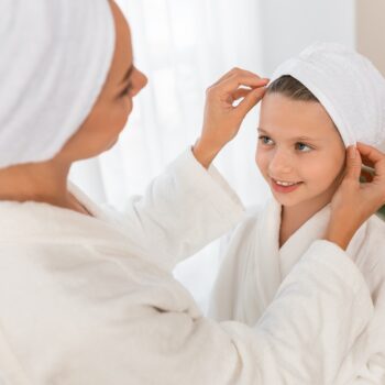 Mom Adjusting Hair Towel Wrap For Her Little Daughter,