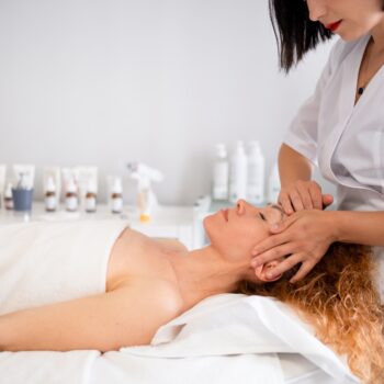 Relaxed young woman receiving spa treatment in beauty salon